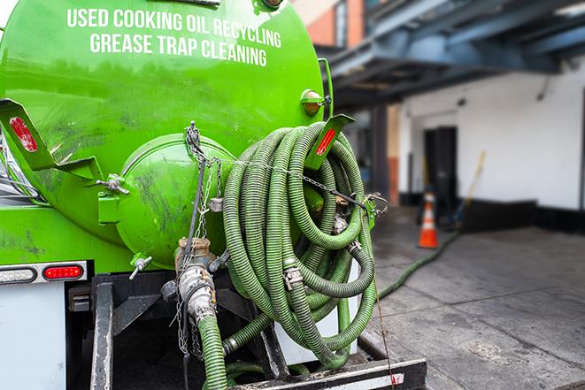 a grease trap pumping truck at a restaurant in Fremont MI